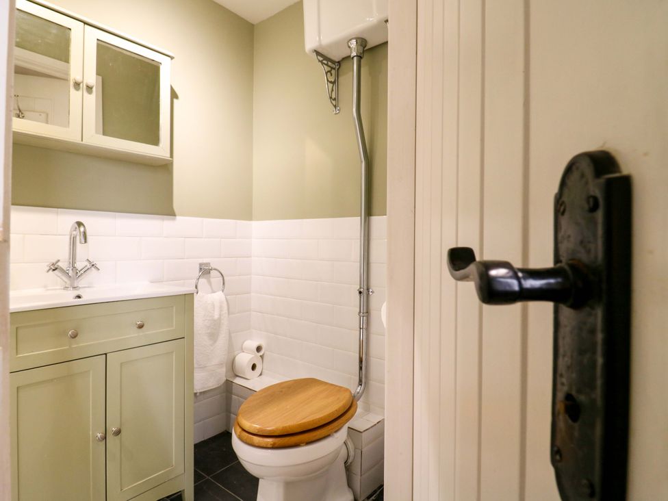 A bathroom with a toilet and sink at The Hayloft in Charing