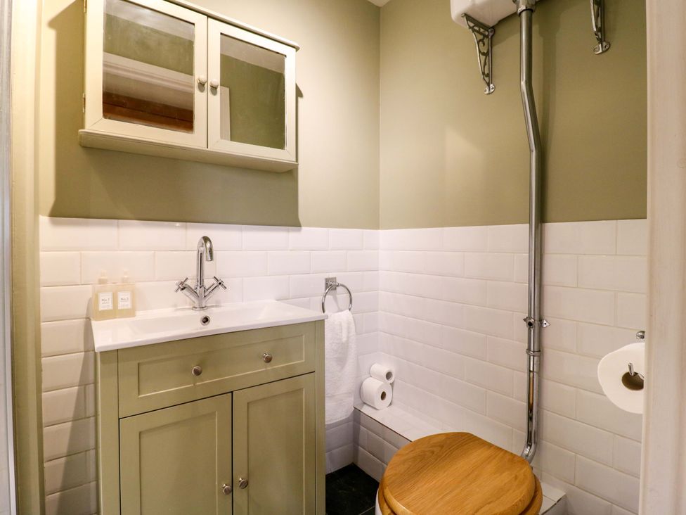 A bathroom with a sink and toilet at The Hayloft in Charing