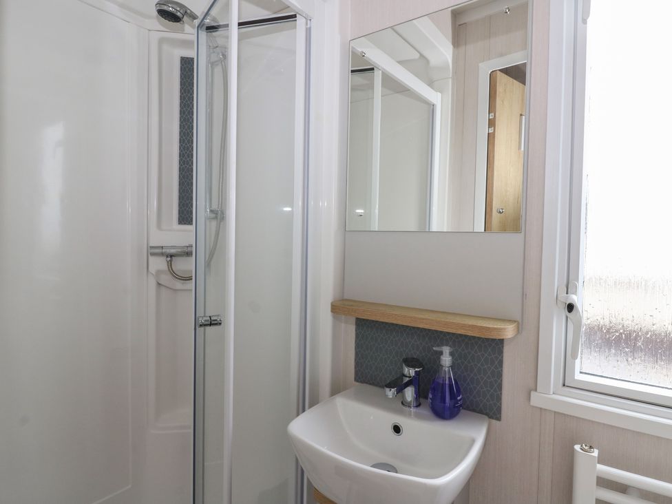 A bathroom with shower and sink at Hafan Y Mor in Aberporth