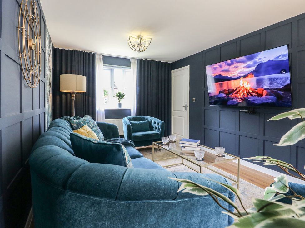 A living room with a sofa and television at 7 Yarnfield Parkway
