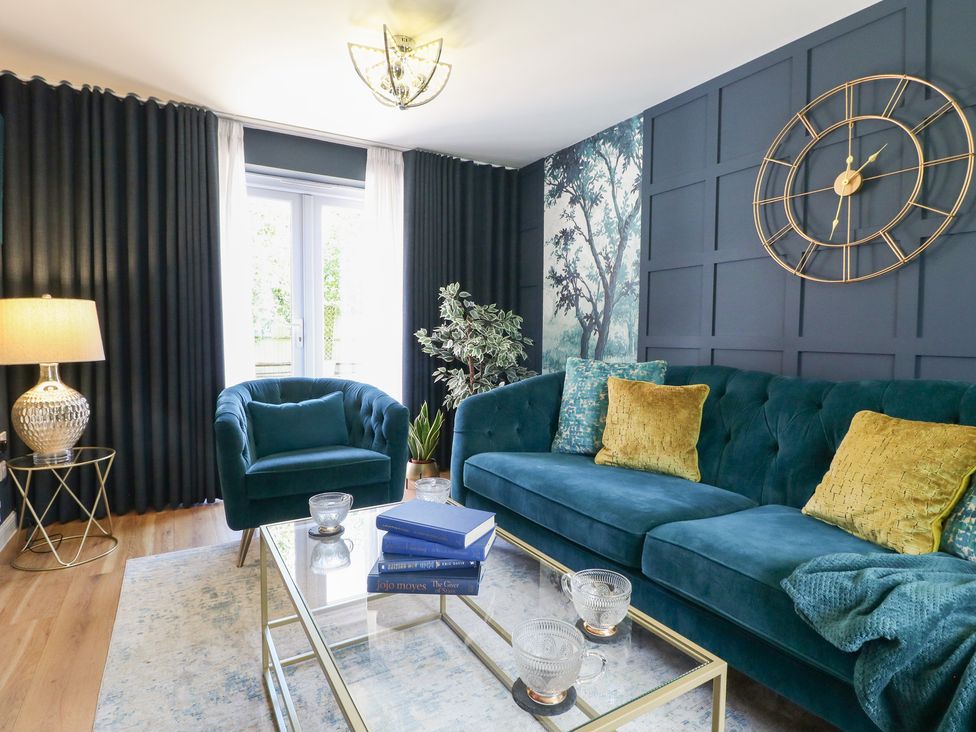 A living room with a sofa and coffee table at 7 Yarnfield Parkway