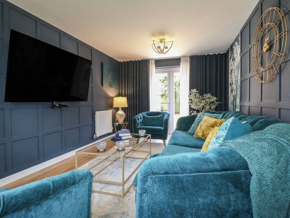 A living room with a sofa and television at 7 Yarnfield Parkway