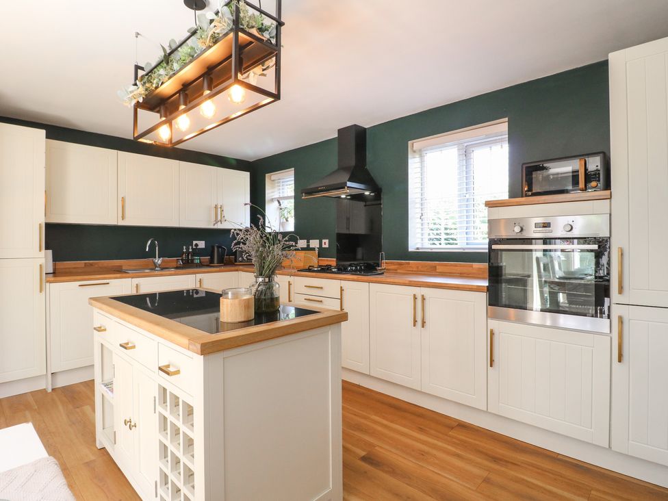 A kitchen with a central island and various appliances at 7 Yarnfield Parkway