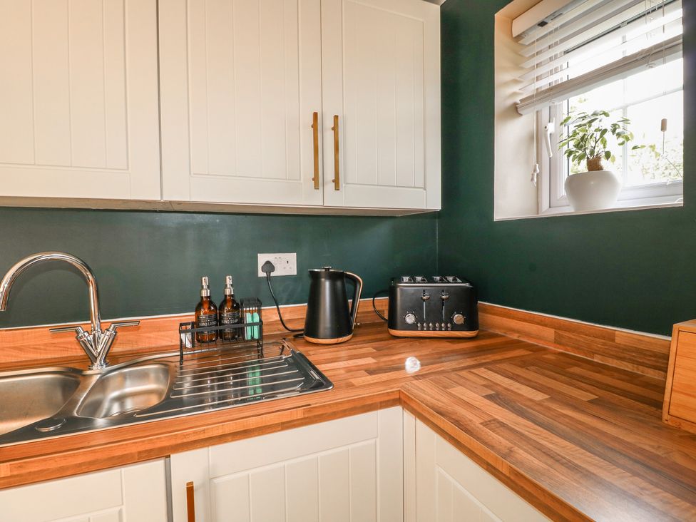 A kitchen with a sink, kettle, and toaster at 7 Yarnfield Parkway