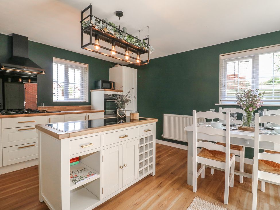 A kitchen with a dining table and chairs at 7 Yarnfield Parkway