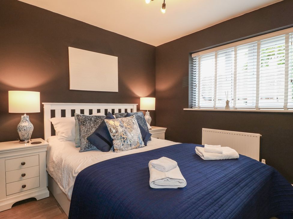 A bedroom with a bed and bedside tables at 7 Yarnfield Parkway