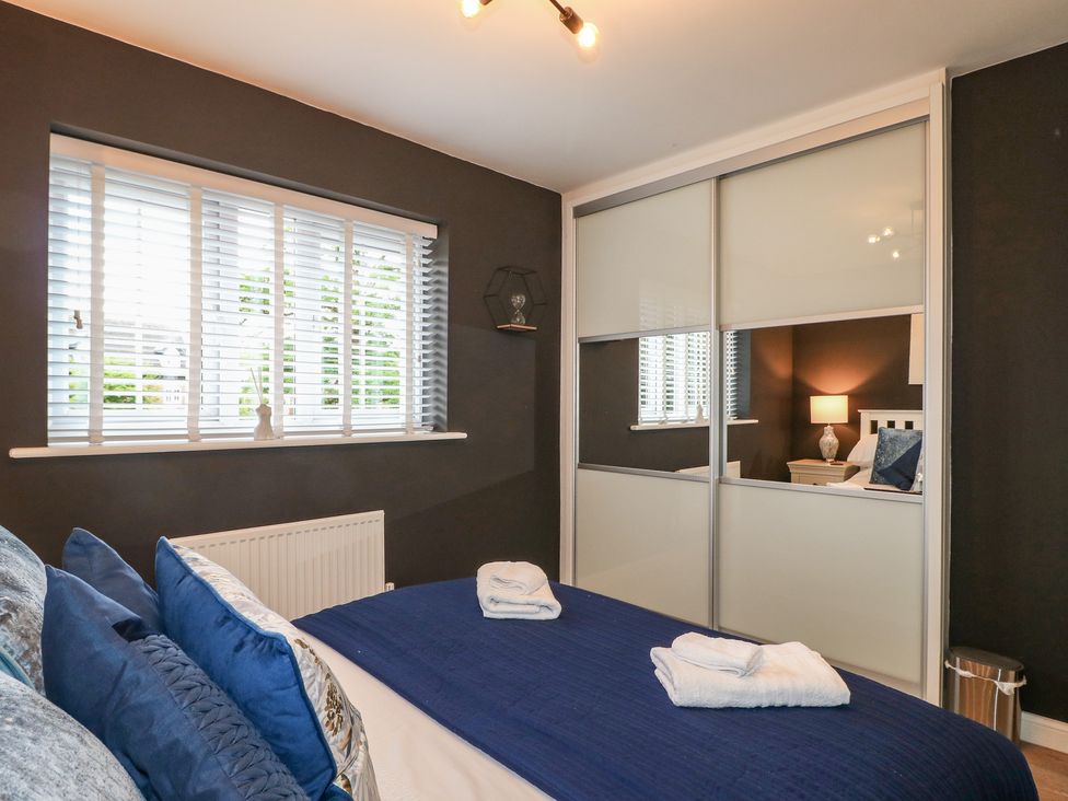 A bedroom with a bed and closet at 7 Yarnfield Parkway