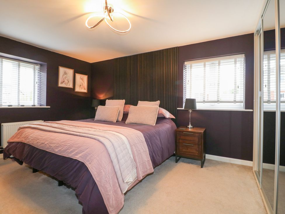 A bedroom with a bed and bedside table at 7 Yarnfield Parkway
