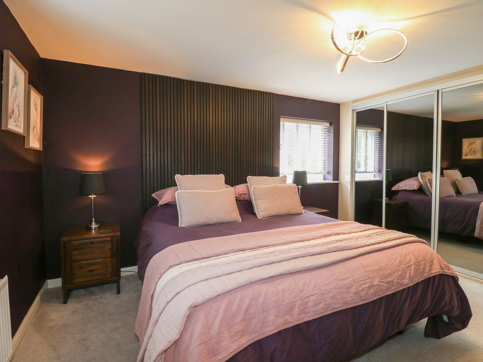 A bedroom with a bed and nightstand at 7 Yarnfield Parkway