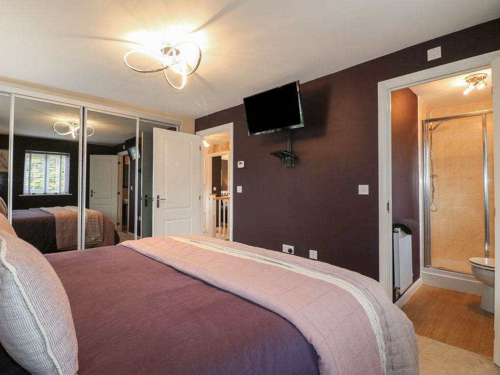 A bedroom with a bed and an en-suite bathroom at 7 Yarnfield Parkway