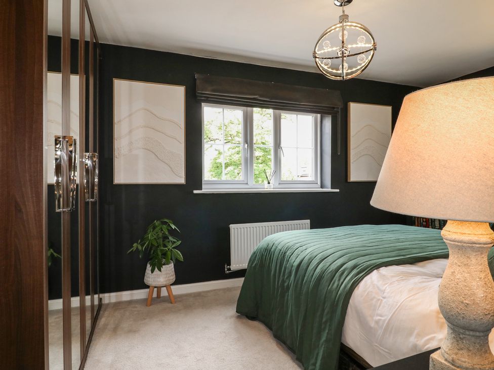 A bedroom with a bed and wardrobe at 7 Yarnfield Parkway