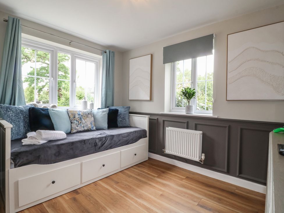 A snug with a sofa and window at 7 Yarnfield Parkway