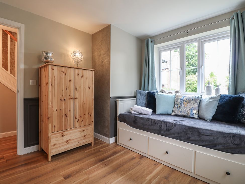A snug room with an armoire and sofa at 7 Yarnfield Parkway