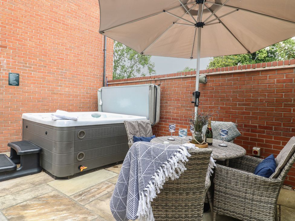 An outdoor area with a hot tub and seating at 7 Yarnfield Parkway 