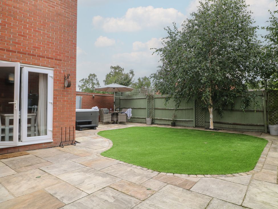 A garden with artificial grass and patio furniture at 7 Yarnfield Parkway