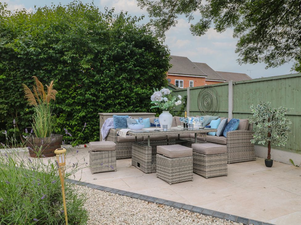 A garden with a patio set and plants at 7 Yarnfield Parkway
