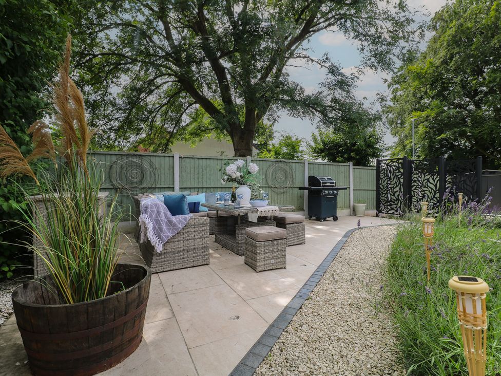An outdoor area with seating and a barbecue at 7 Yarnfield Parkway