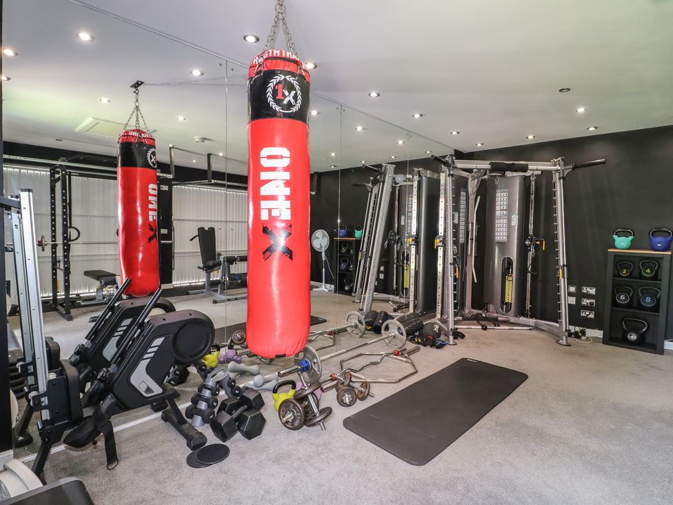 A gym with various fitness equipment and a punching bag at 7 Yarnfield Parkway