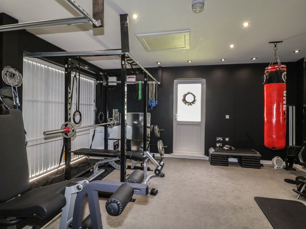 A gym with exercise equipment and a punching bag at 7 Yarnfield Parkway