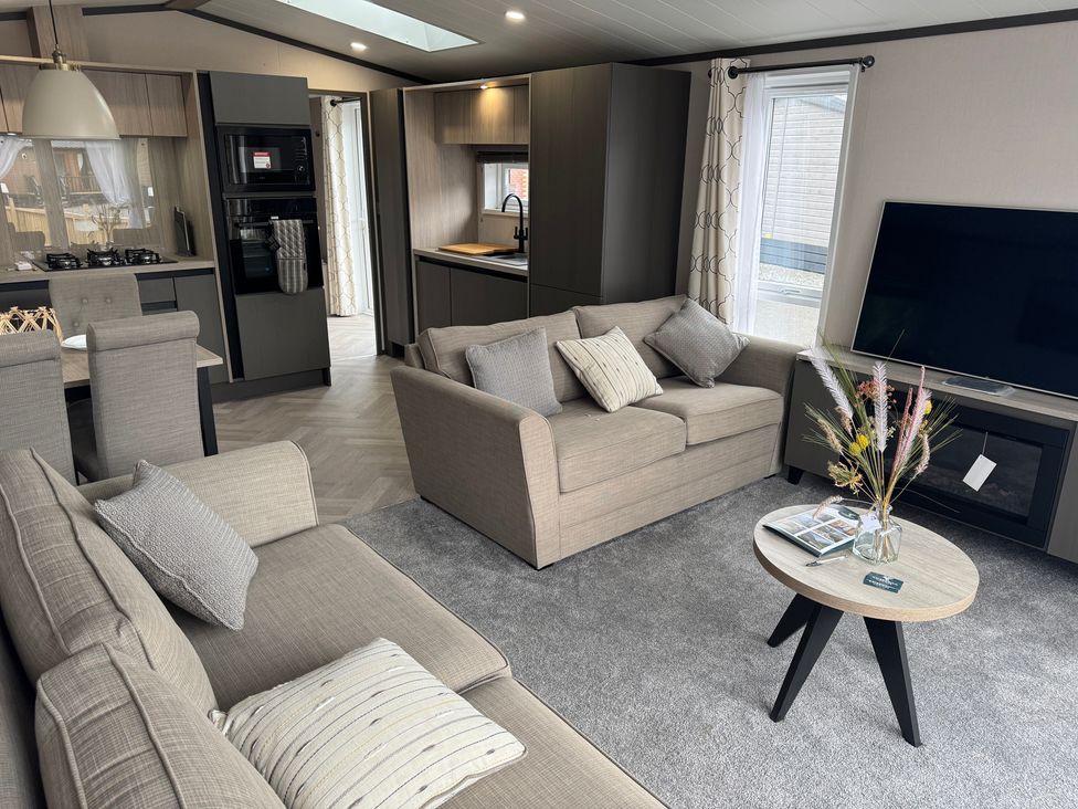 A living room with a sofa and coffee table at Lime Tree Lodge