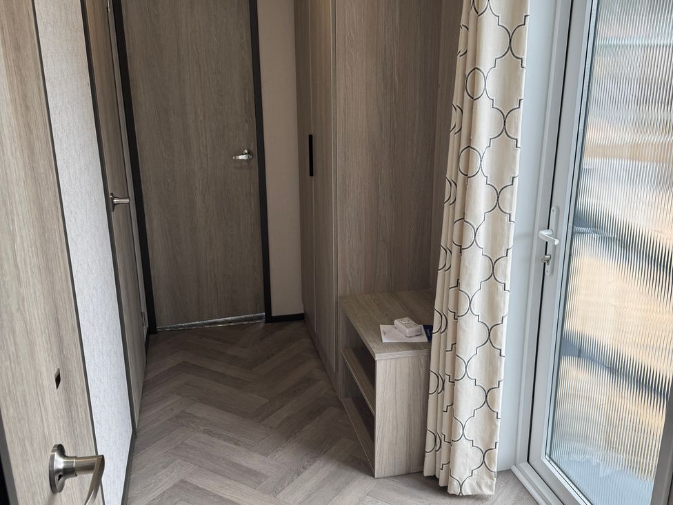 A hallway with a door and a window at Lime Tree Lodge