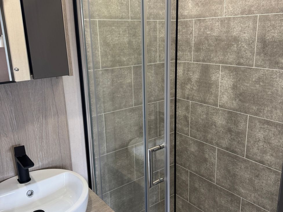 A bathroom with a sink and a shower at Lime Tree Lodge