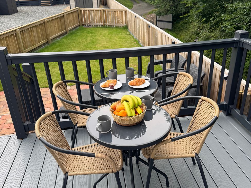 A table with snacks and mugs on a deck at Lime Tree Lodge