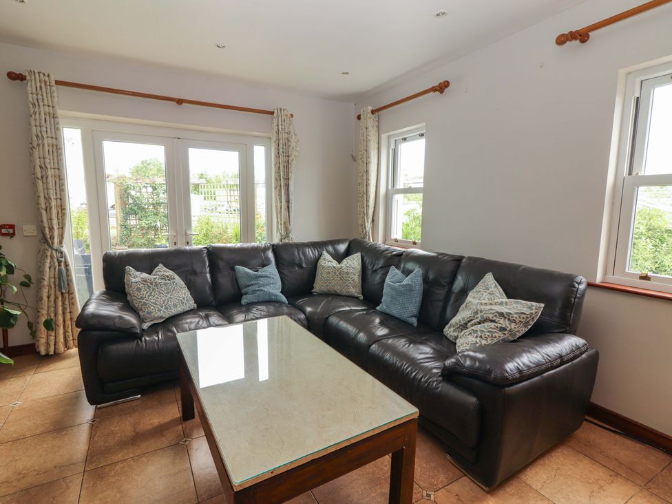 A living room with a sofa and coffee table at Ash House in Ballyvaughan