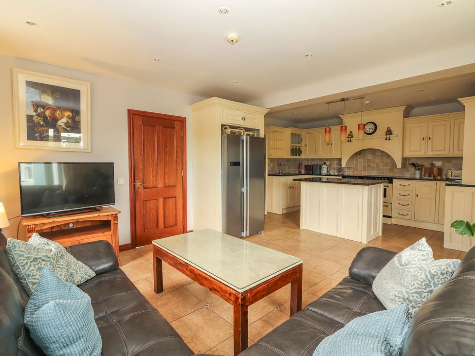 A living room with a sofa and television in Ash House Ballyvaughan