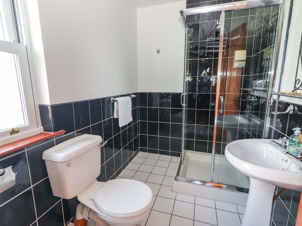 A bathroom with a shower enclosure and toilet at Ash House in Ballyvaughan