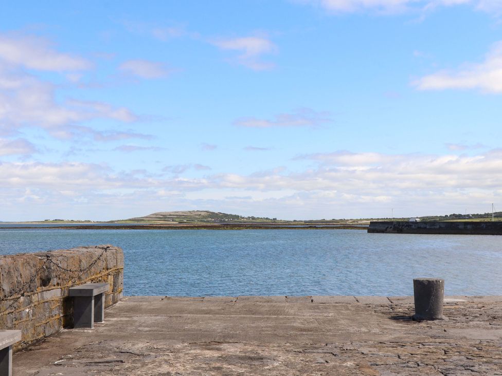A view of water and sky from a stone pier at Ash House in Ballyvaughan