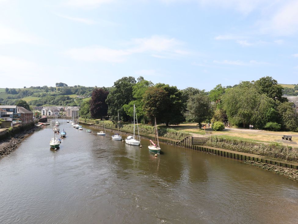 A river with boats and trees near a park at Tigley Meadow Coach House in Totnes