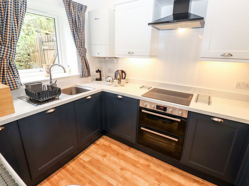 A kitchen with a sink and cooker at School Cottage in Windermere