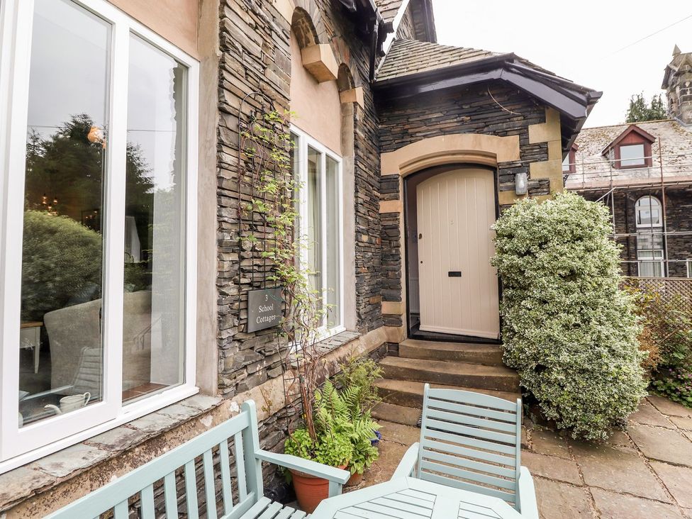 An entrance with a door and bench at School Cottage in Windermere