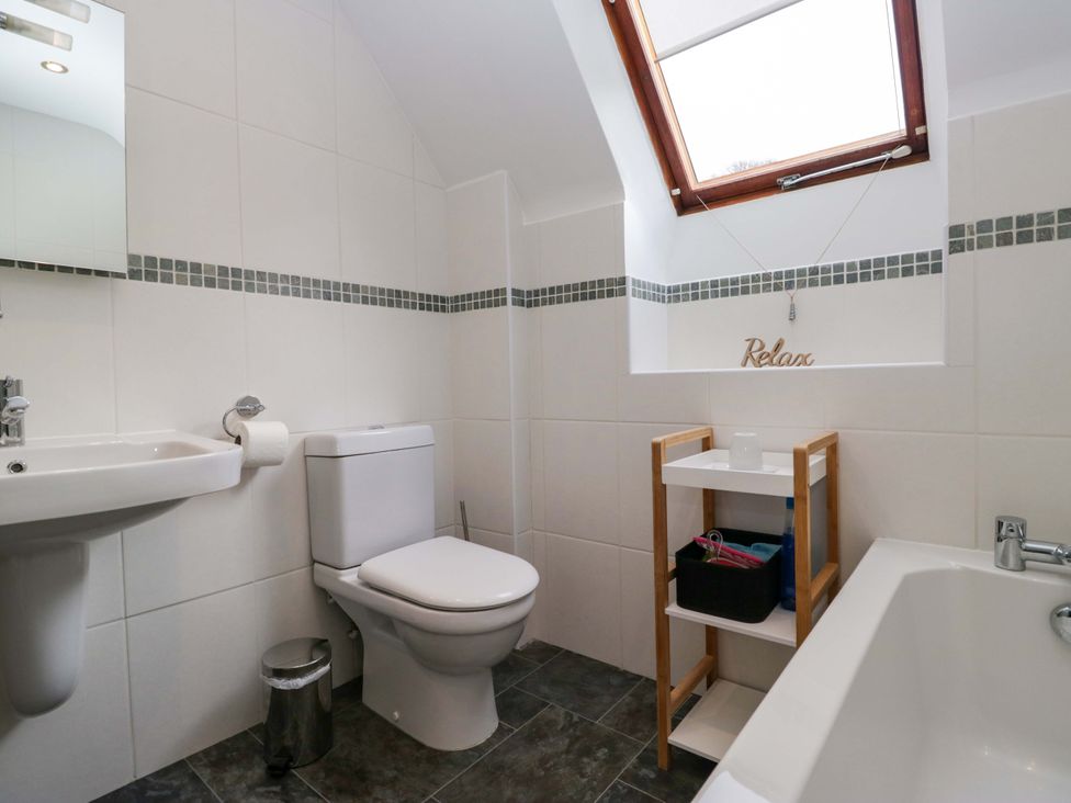 A bathroom with a toilet and a sink at School Cottage in Troutbeck Bridge near Windermere