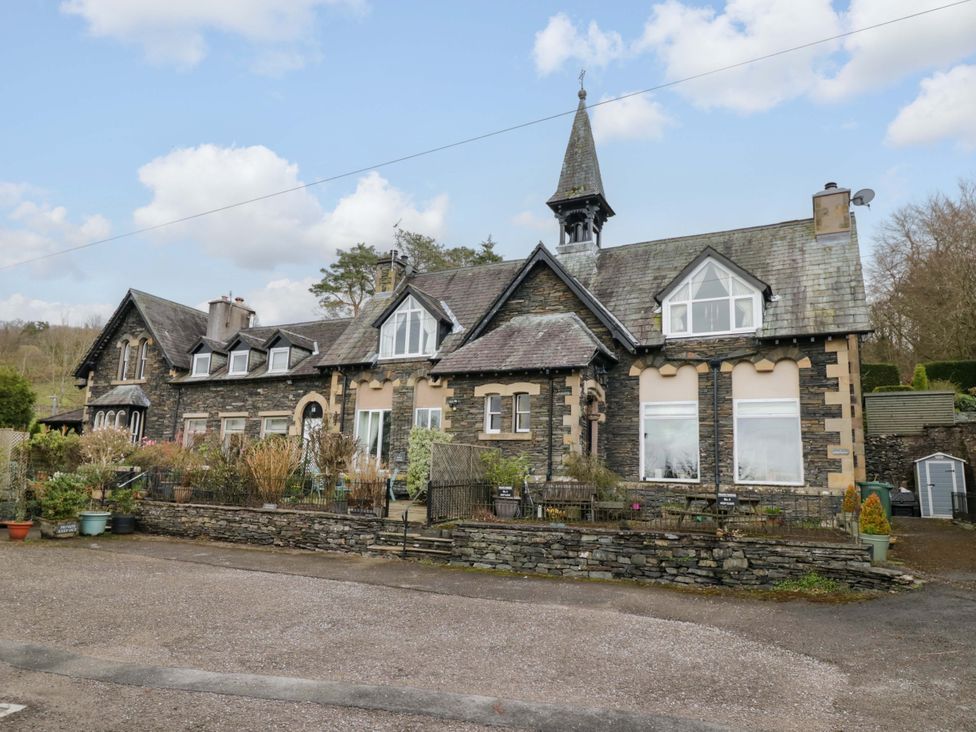 An exterior view of a house with a garden at School Cottage in Troutbeck Bridge near Windermere
