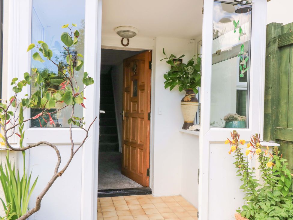 An entrance with a door and potted plants at The White House in Piddletrenthide