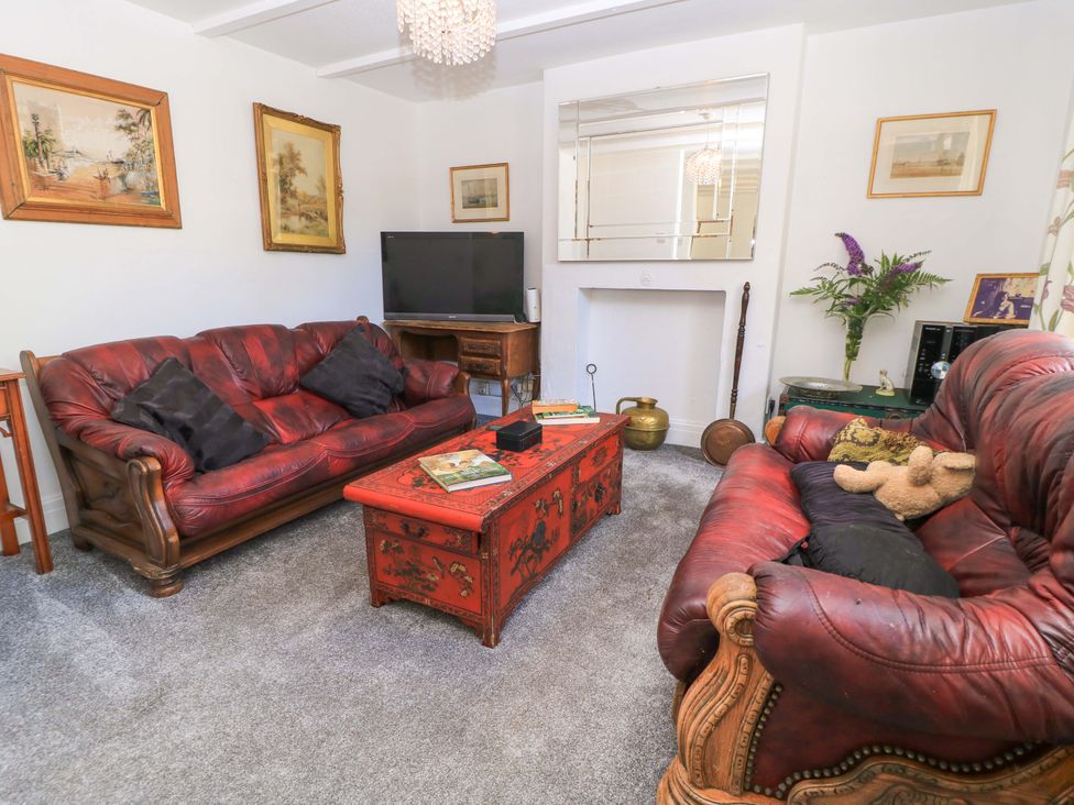 A living room with a sofa and television at The White House in Piddletrenthide