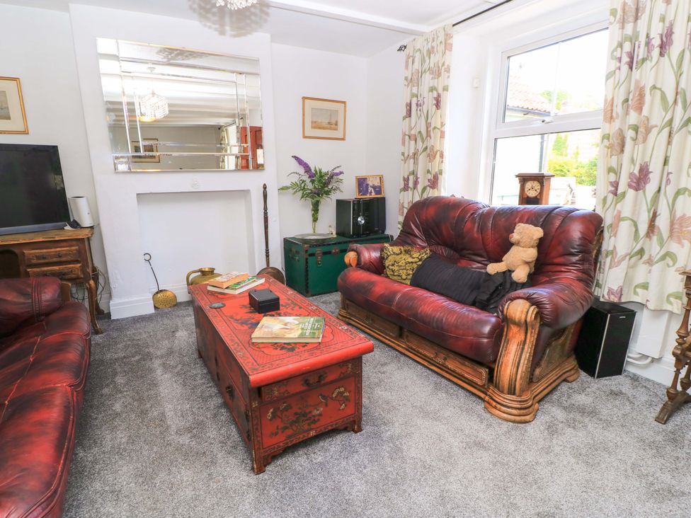 A living room with a television and sofa at The White House in Piddletrenthide