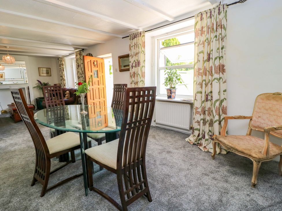 A dining room featuring a glass table with chairs at The White House in Piddletrenthide