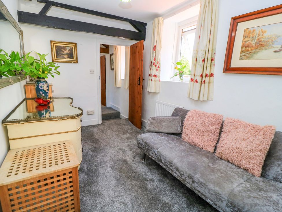 A living room with a sofa and table at The White House in Piddletrenthide