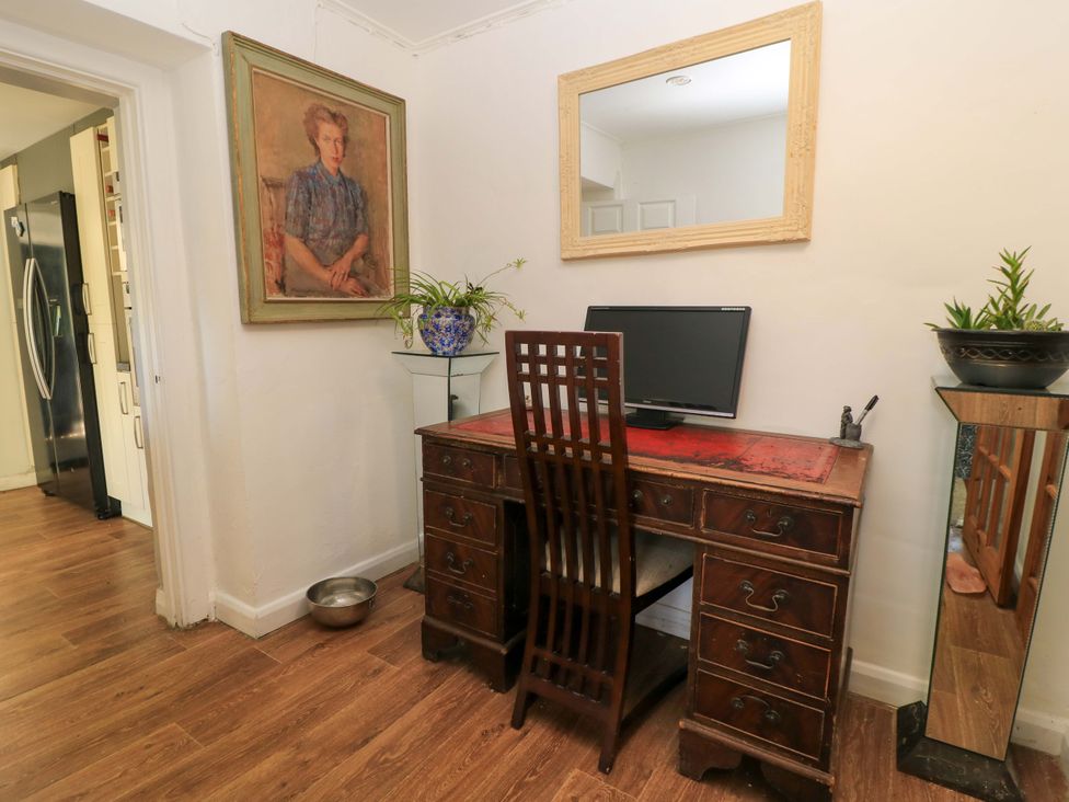 A home office with a desk and computer monitor at The White House in Piddletrenthide