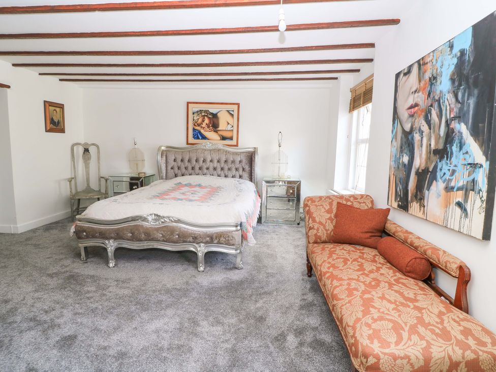 A bedroom with a bed and artwork at The White House in Piddletrenthide