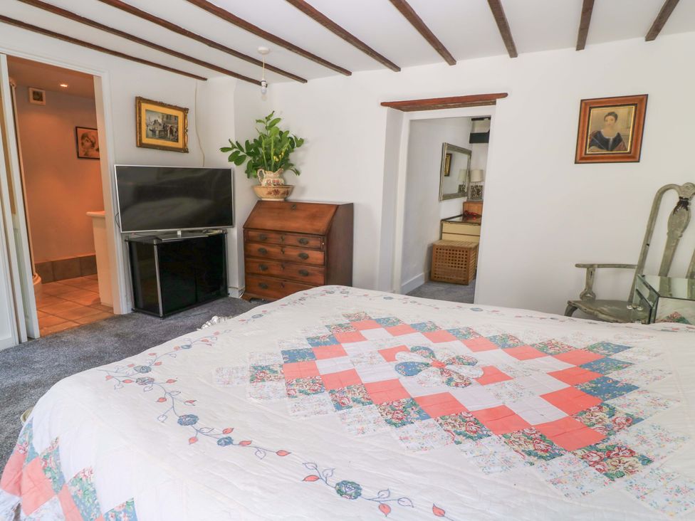 A bedroom with a bed and television at The White House in Piddletrenthide