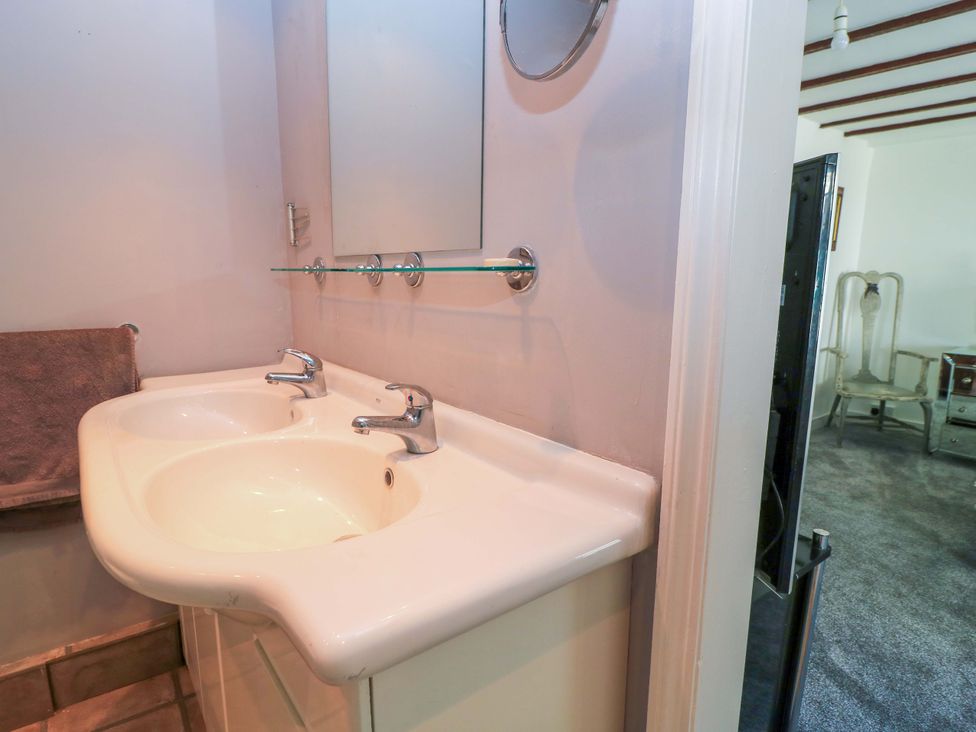 A bathroom with a double sink and a mirror at The White House in Piddletrenthide
