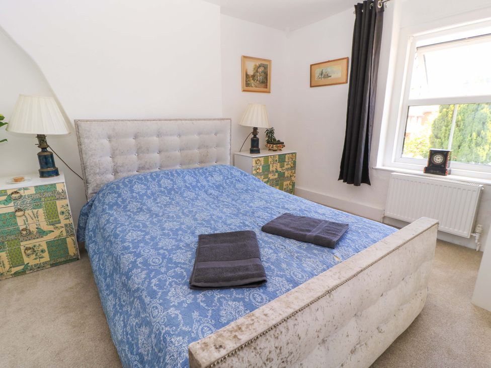A bedroom with a bed and bedside tables at The White House in Piddletrenthide
