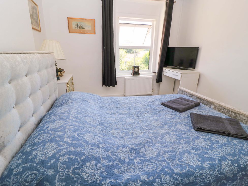 A bedroom with a bed and a television at The White House in Piddletrenthide