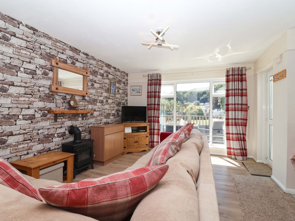 A living room with a sofa, television and coffee table at Boo’s Bungalow in Callington near Gunnislake
