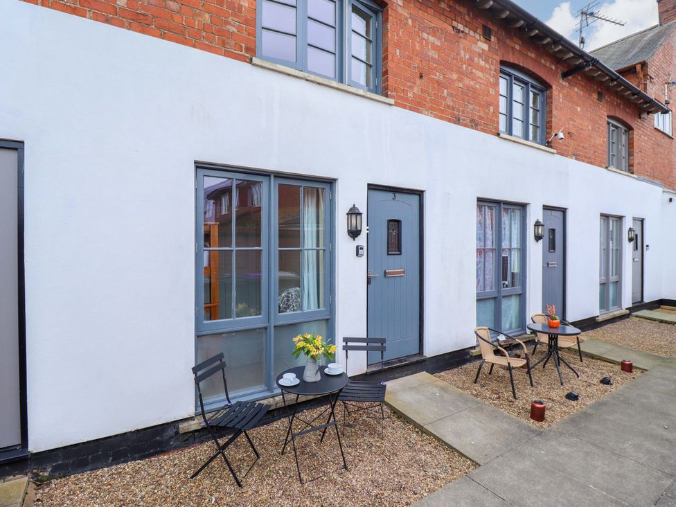 An outdoor area with seating and tables at 3 The Old Drill Hall Alford