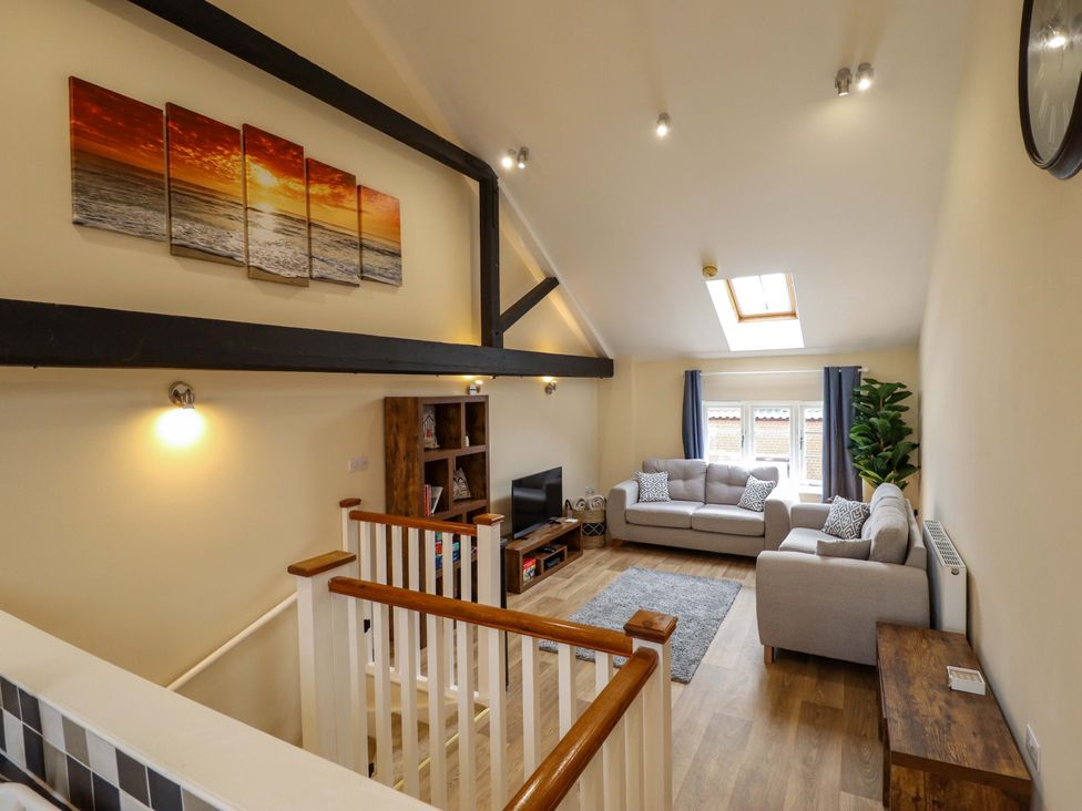 A living room with sofas and a television at 3 The Old Drill Hall Alford